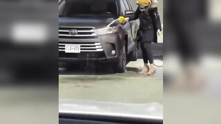 Woman spilling gasoline all over car thinks it's a water hose