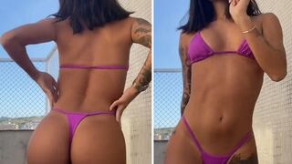 Tattooed babe in sexy thong bikini with bubble butt